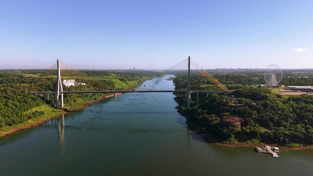 Foz do Iguacu - Paraguay Border Crossing: Aerial Shot of the Modern Cable-Stayed Bridge, Parana River, and Yup Star Wheel on a Sunny Day