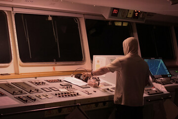 monitoring electronic consoles and navigation displays on the bridge of a vessel navigating in dark night conditions © debjit