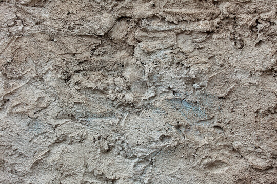 Construction and renovation rough grey concrete wall texture with uneven plaster finish for architectural background and industrial design projects