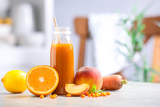 Tasty smoothie in bottle and ingredients on grey table indoors, space for text