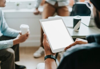 Person holding blank tablet during casual office meeting © Rawpixel.com