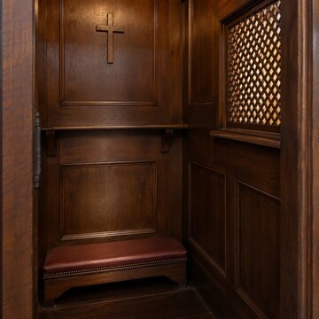 Wooden confessional booth with cross in a church setting  