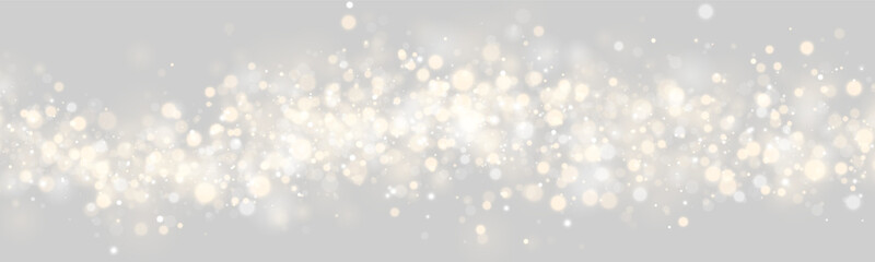 Obraz premium A dense cluster of glowing bokeh lights creates a sparkling effect. The lights are circular and soft, blending warm gold and cool silver tones. This luminous pattern enhances festive and.