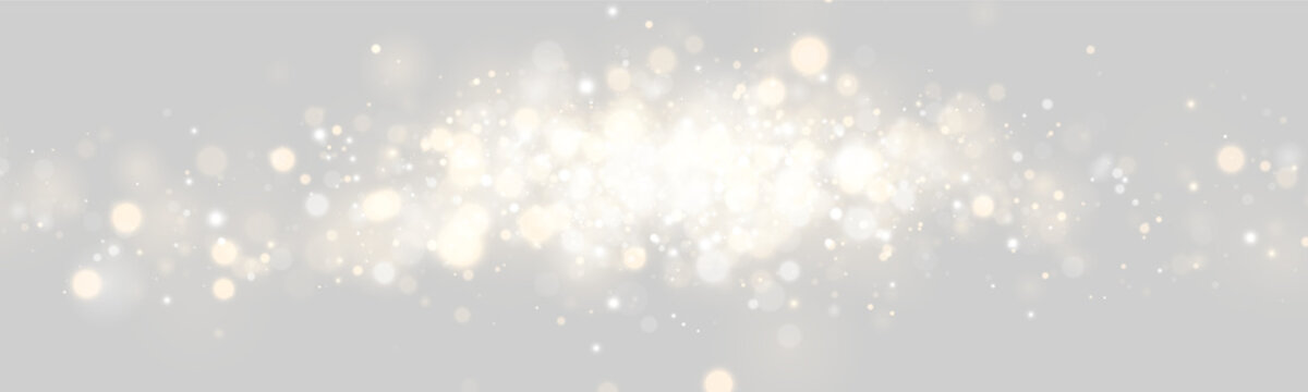 A dense cluster of luminous bokeh lights floats horizontally. The glowing orbs vary in size and shimmer with warm gold and cool silver tones. This sparkling scene creates a festive and.