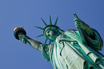 Majestic Statue of Liberty Against a Clear Blue Sky © MarekLuthardt