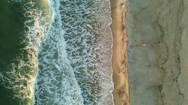 Aerial view of people enjoying Carolina Beach at sunrise, in New Hanover County, North Carolina near Wilmington