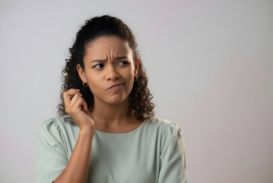 Person with a skeptical facial expression and a questioning gaze conveying doubt and suspicion in an expressive portrait highlighting disbelief and critical evaluation through nonverbal communication.