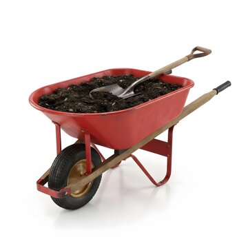 A sturdy red metal wheelbarrow filled with dark fertile soil and a metal shovel resting on top isolated against a plain white studio