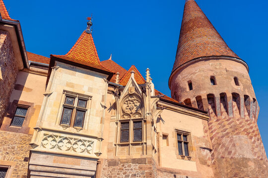 Gothic tower and ornate stone facade details of Corvin Castle in Hunedoara Romania