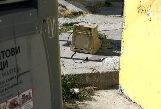Broken crt monitor discarded as electronic waste on street