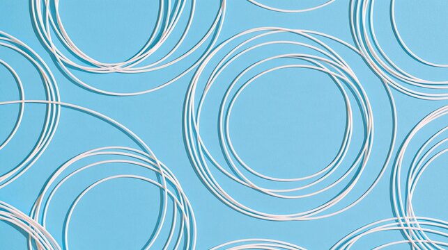 Seamless pattern of multiple white circles on a light blue background. the circles are arranged in a repeating pattern, creating a sense of depth and dimension.