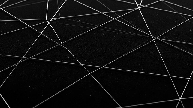 Black and white abstract background with multiple white lines intersecting each other in a diagonal pattern.