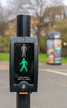 UK pedestrian crossing push button unit showing green walk signa