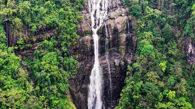 Cinematic aerial drone footage of Shangliar Falls, a stunning multi-tiered cascading waterfall located in Meghalaya, Northeast India, near the Sylhet border of Bangladesh.