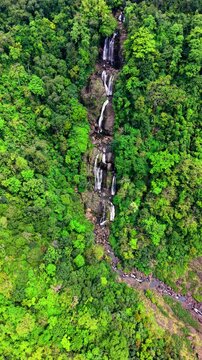 Cinematic aerial drone footage of Shangliar Falls, a stunning multi-tiered cascading waterfall located in Meghalaya, Northeast India, near the Sylhet border of Bangladesh.