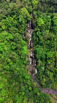 Cinematic aerial drone footage of Shangliar Falls, a stunning multi-tiered cascading waterfall located in Meghalaya, Northeast India, near the Sylhet border of Bangladesh.