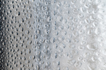 Close up of Black and White Abstract Water Drops on Glass Background © Anna Hoychuk