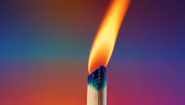 Lit matchstick with bright orange yellow flame rising from colorful gradient background. Fire and Energy concept
