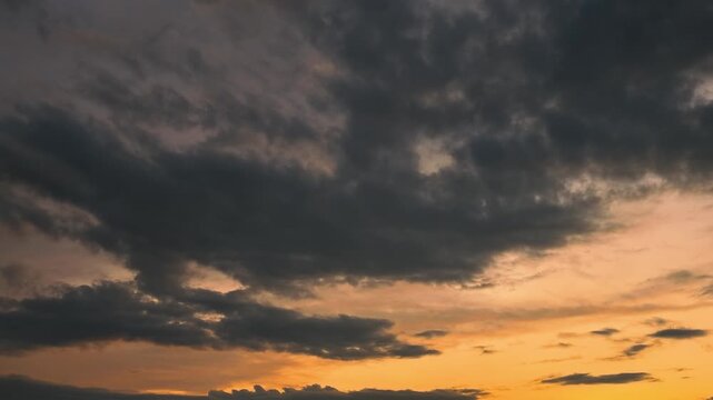 Timelapse Video of Dark Storm Clouds Gathering Over Golden Sunset Sky