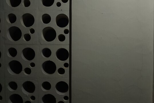 modern white breeze block wall with perforated round hole pattern