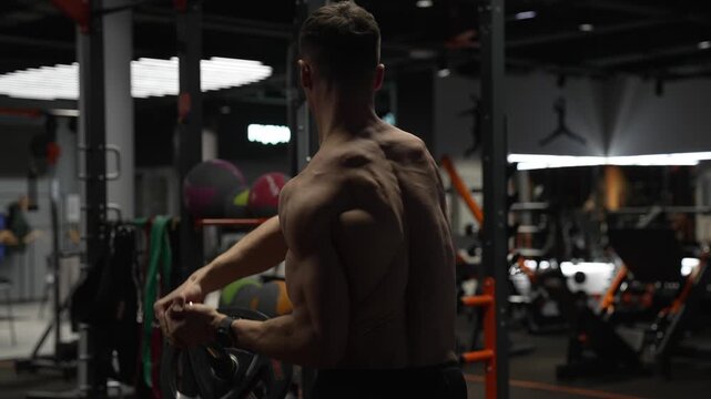 Fitness and bodybuilding. Landmine shoulder to shoulder press. Shoulder exercise. Workout training. Athletic man performing landmine exercises with barbell. Strength and fitness