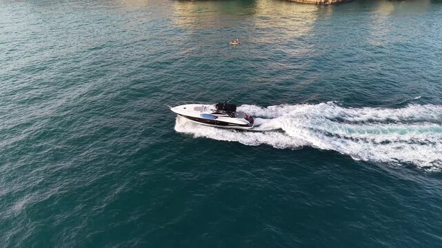 Aerial view of speedboat cruising near benagil sea caves in algarve