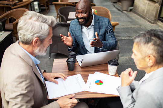 Business professionals having strategy meeting at outdoor cafe