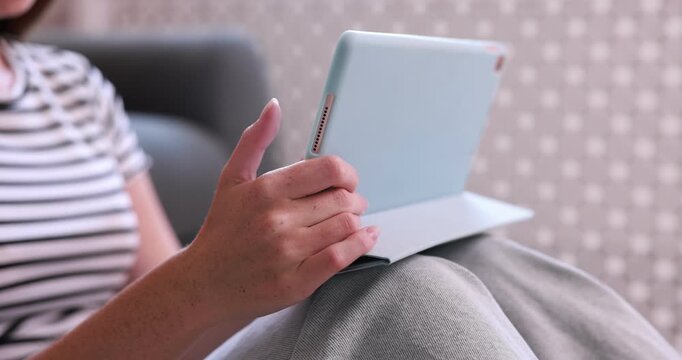 Teenage girl using tablet computer at home, closeup