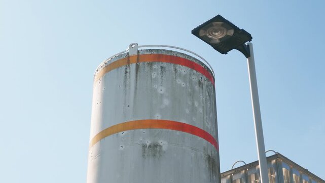 Industrial Bulk Storage Silo Tank with Orange Safety Stripes