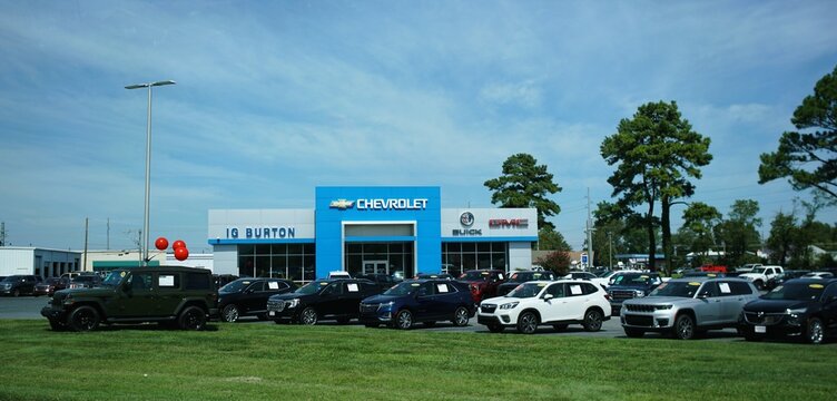 Lewes, Delaware, U.S.A - Sept 9, 2026 -IG Burton dealership showcasing Chevrolet, Buick, and GMC vehicles arranged across a large lot beside a modern showroom.
