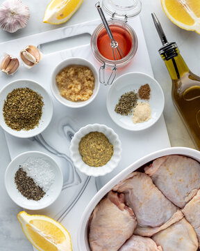 Above view of ingredients for making a Greek chicken marinade. 