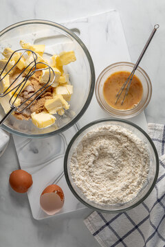 Above view of mixing bowls filled of ingredients for making pecan pie cookies. 