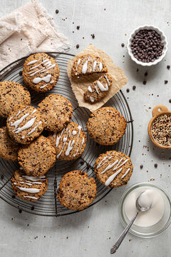 Homemade chocolate chip quinoa cookies on a cooling rack with icing sugar.