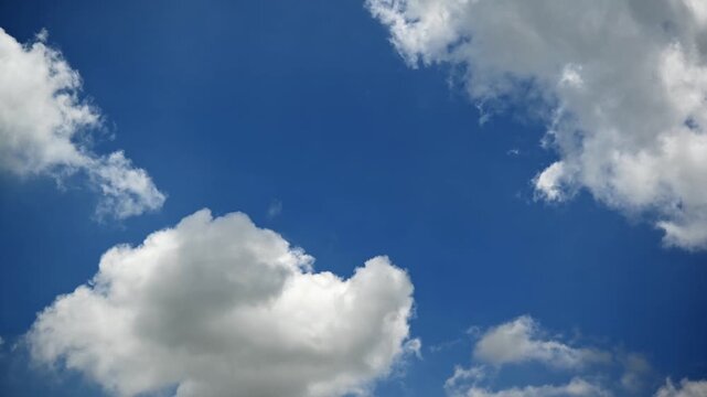 video timelapse 4k Beautiful Blue Sky with Fluffy White Clouds on a Bright Summer Day, Peaceful Cloudscape and Natural Atmosphere Background