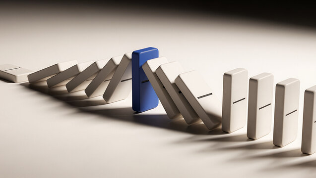 Blue domino standing firm stopping chain of falling white dominoes, resilience and risk management concept with copy space for text