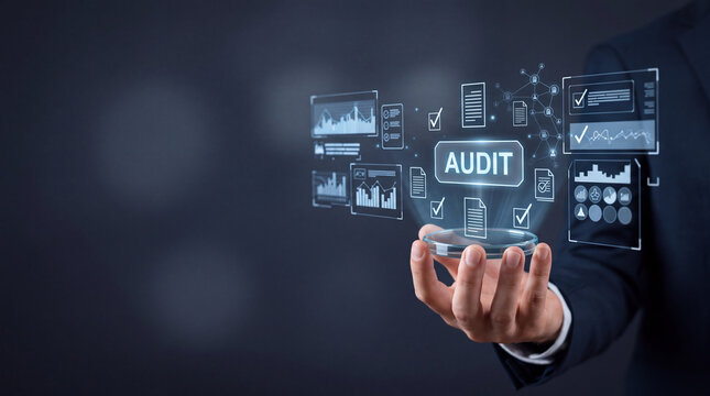 Professional businessman holding futuristic digital interface with audit text and financial data icons for internal compliance, business report analysis, and quality control management concept.