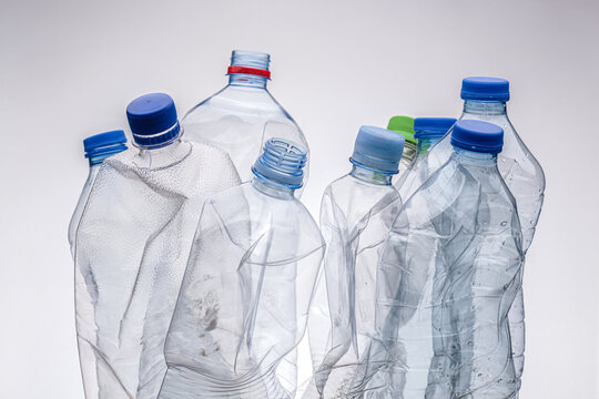 Group of smashed plastic water bottles. Recycle concept studio photo.