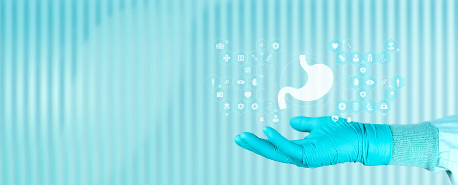 Concept of education about gastric cancer and digestive health. Doctor's hand displays a stomach icon. Isolated with space for text. Emerald green background.