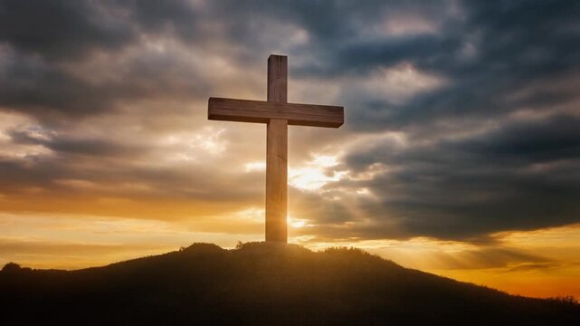 A large wooden cross stands on a hill against a dramatic sunset sky with clouds.