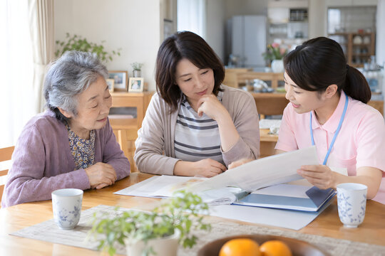 Japanese family discussing senior care with a female caregiver