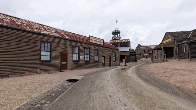 Historical gold rush town with wooden buildings and gravel road at sovereign hill mining museum in ballarat australia.