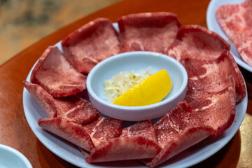 Fototapeta premium Raw Hanwoo Beef Tongue, marbled Korean Style Meat prepared on the plate