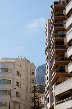 sunlit Mediterranean city with hillside properties in the mountain. 
