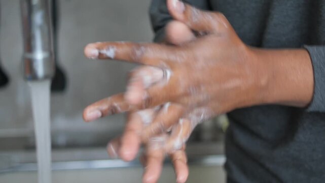 Close-up of a person washing hands with soap under running water at a sink hygiene and sanitation concept cinematic footage