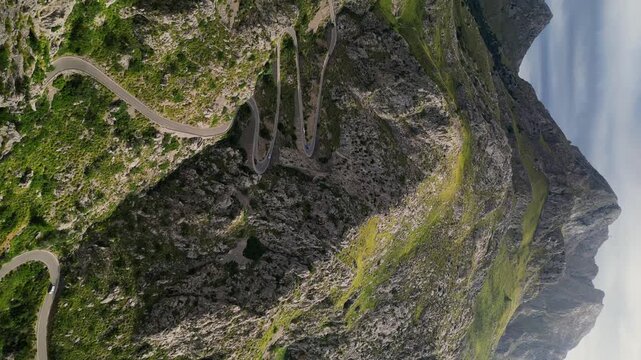 Dramatic aerial view of Sa Calobra road in Mallorca. Travel, landmark and nature vertical footage