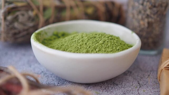 Green powder and natural ingredients displayed on a table