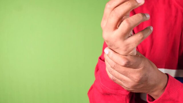 Close up of man holding wrist experiencing pain and discomfort showing symptom