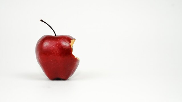 Partially bitten fresh red apple isolated on white