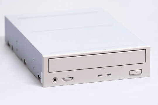 Old retro internal optical CD-ROM drive for desktop PC isolated on clean white backdrop. Vintage computer hardware component from the 1990s.