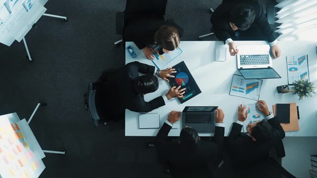Top view of businesswoman bring financial statistic graph during meeting. Manager putting tablet with stock market investment on table while business team brainstorming marketing idea. Directorate.